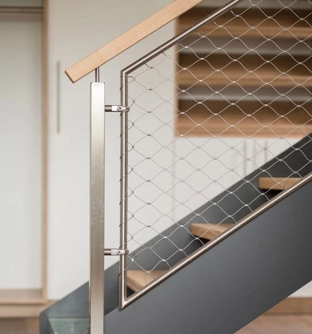 Cable mesh stair screen with stainless steel posts and transparent safety infill