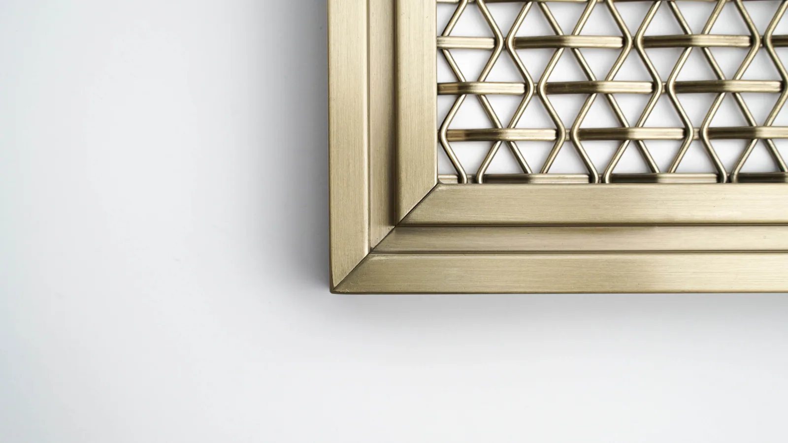 Custom perimeter frame detail for woven metal mesh panel