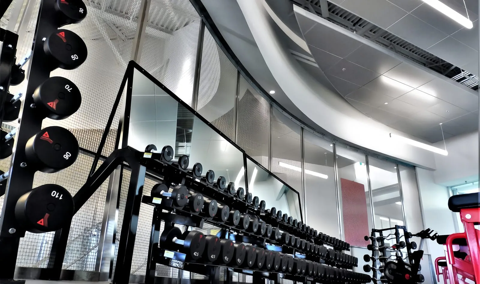 Custom architectural metal mesh route with project-specific track and ceiling condition