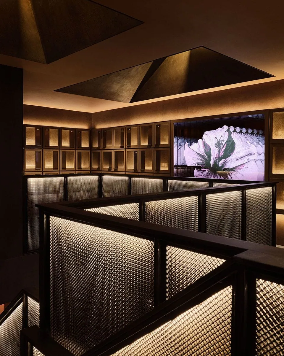 Framed architectural metal mesh wall panels with warm backlit interior detail
