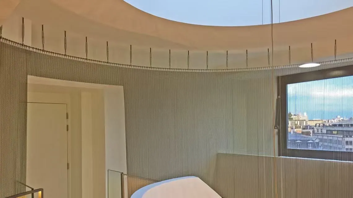 Hanging metal curtain system with track and flexible mesh layer