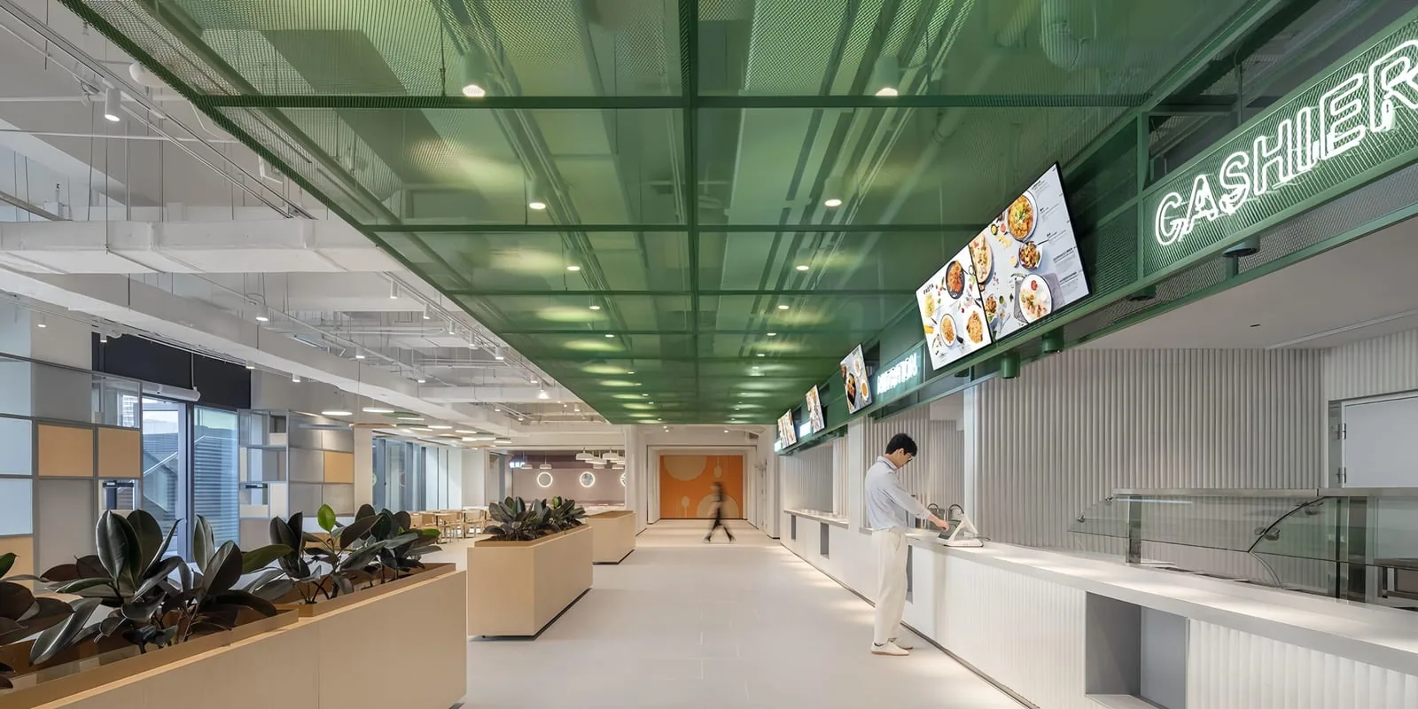 Panelized green architectural metal mesh ceiling installation in a commercial interior
