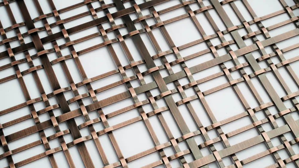 Warm bronze woven wire mesh finish sample with mixed metal tones